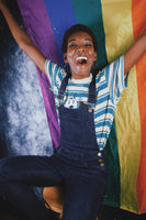 Person happily holding a pride flag